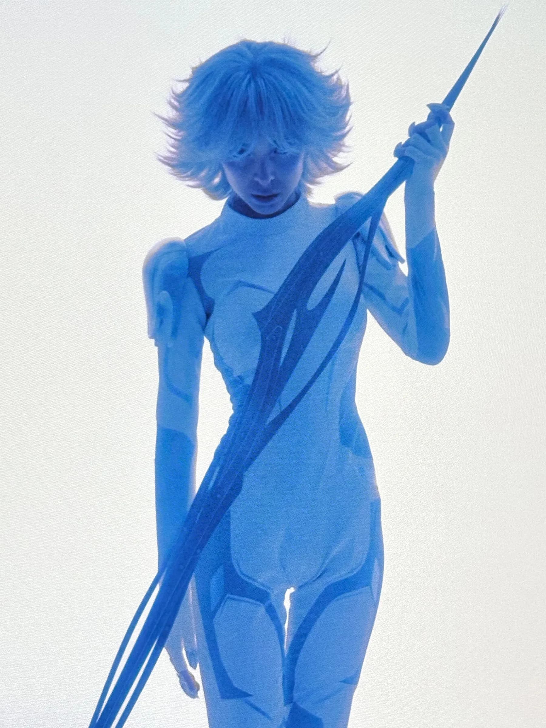 The silver bodysuit under blue light