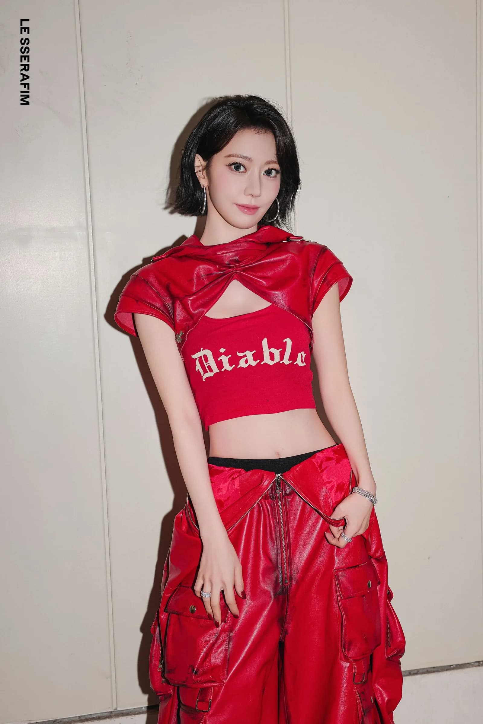 LE SSERAFIM — custom red leather cropped top and cargo trousers