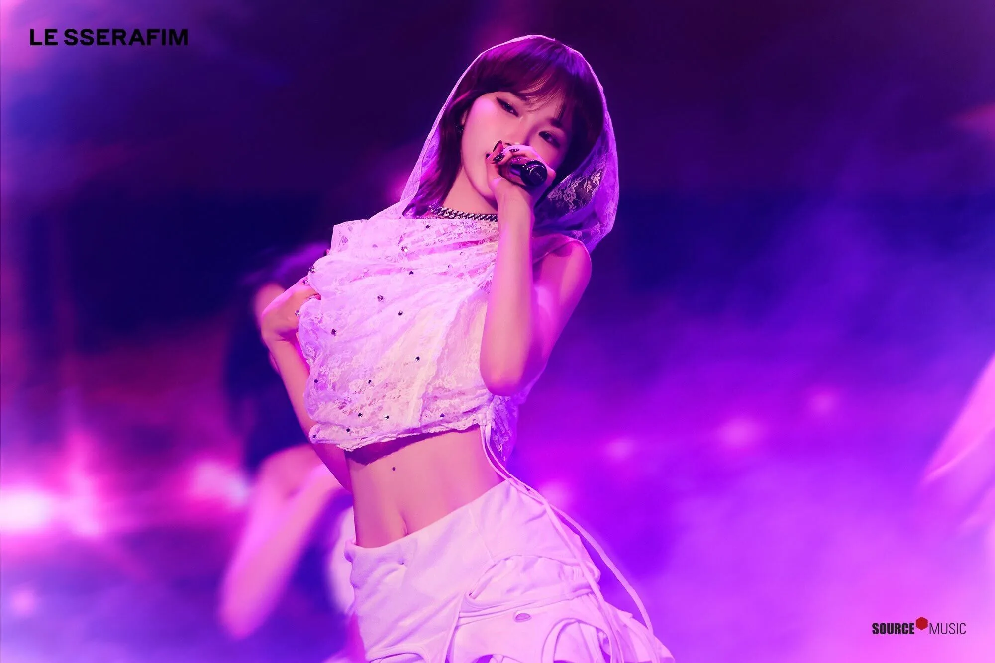 LE SSERAFIM on stage in a custom white crystal-fringe look
