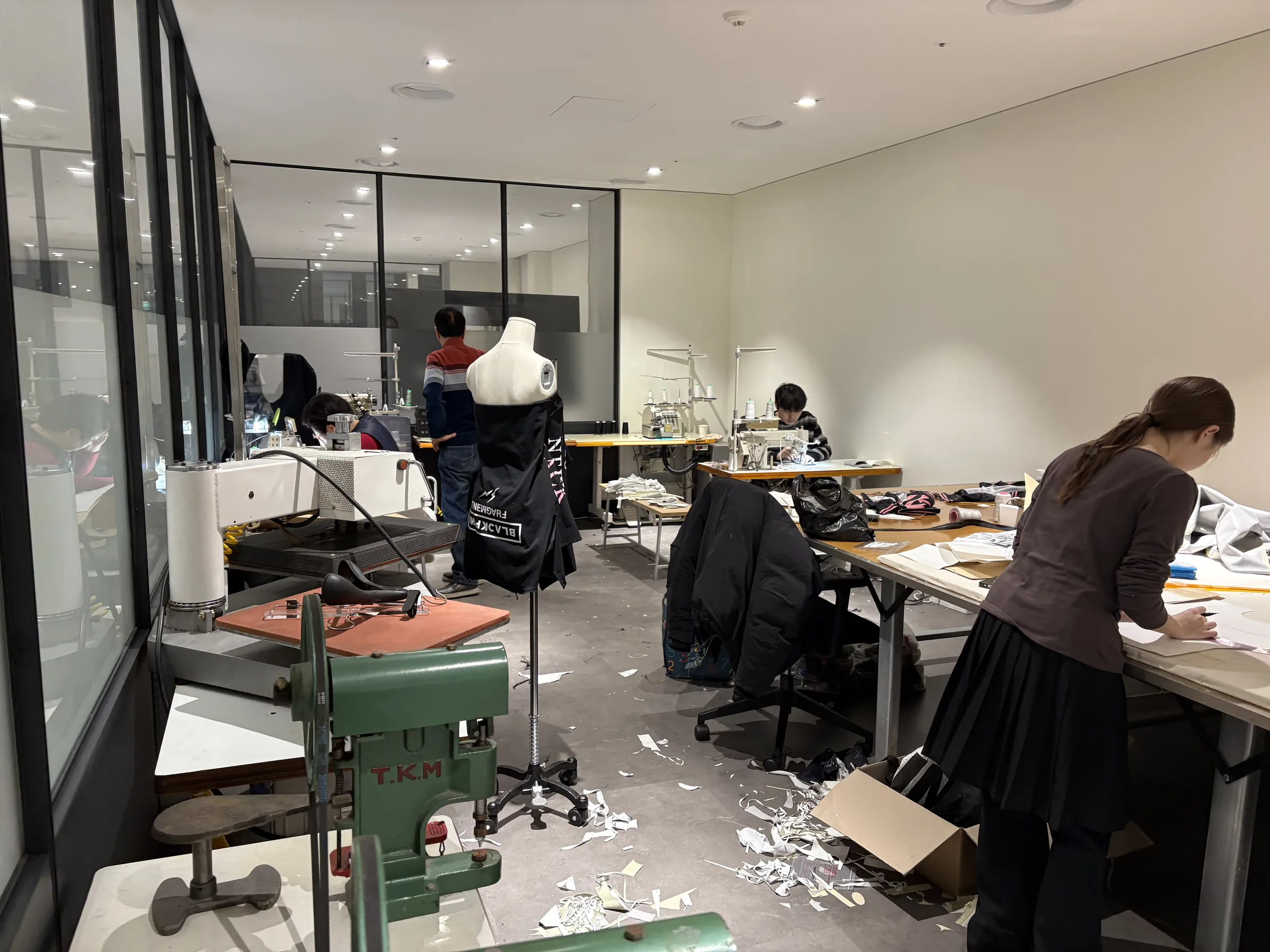 The atelier workroom, Seoul — machines, tables and the team at work